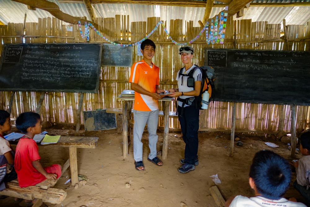 Day 3 trek - Moni giving books and pens to the school