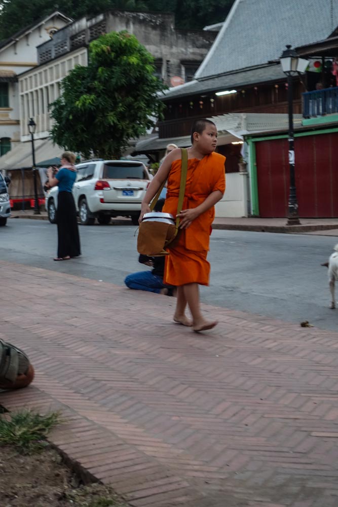 Chubby monk carrying alms