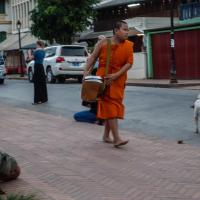 Chubby monk carrying alms