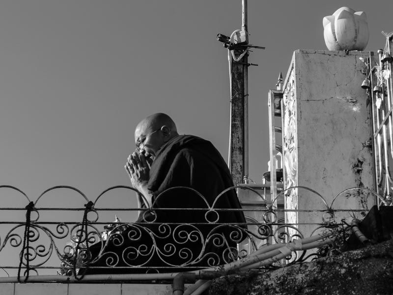 Monk praying at Golden Rock