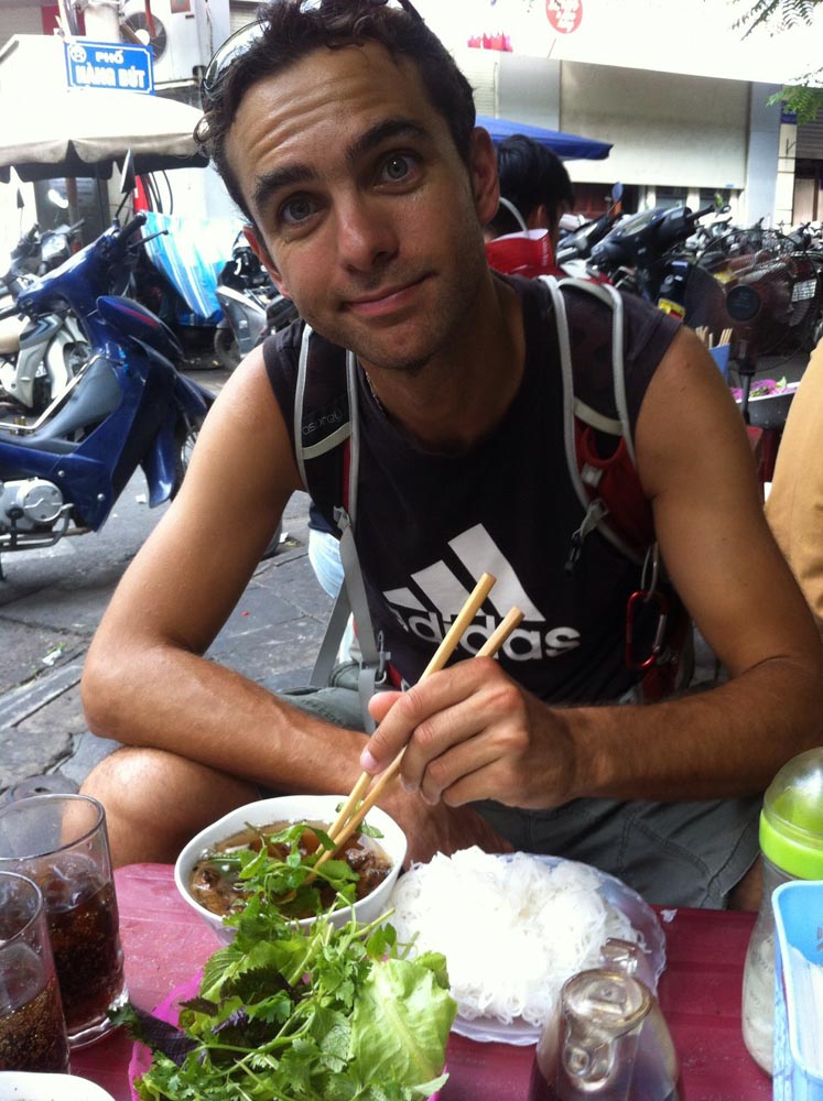 Alex eating Bun Cha in the streets of Hanoi